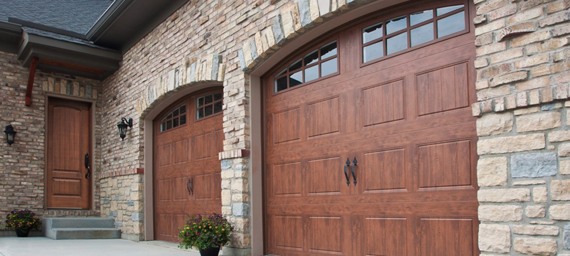 Raynor Carriage House Garage Doors with Wood-like Accufinish and Stockton Glass